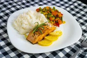 fried-salmon-steak-with-lemon-rice-and-vegetables-photo